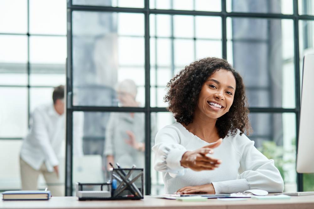 BRIDGE Newsletter banner smiling business woman pointing at you.